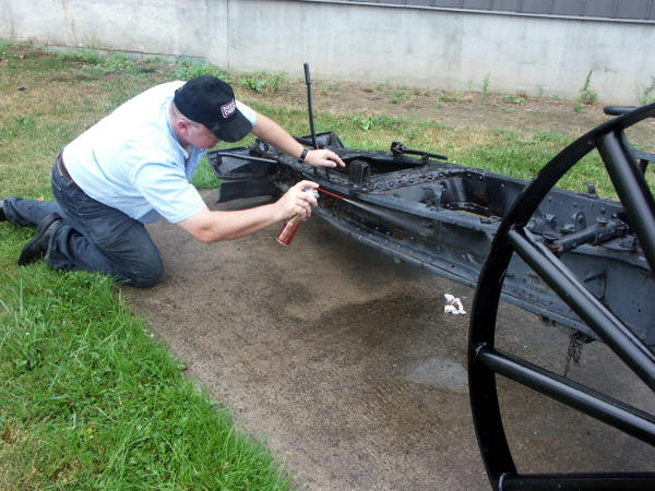 Bruce Hector, professional rust fighter, applying corrosion prevention compound on a military monument