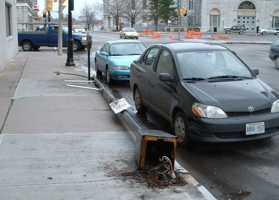 Fallen lamppost corroded at its base